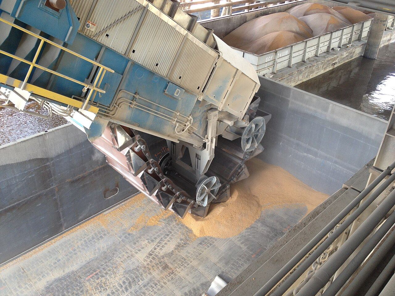 Barge unloading bulk material at a waterfront site