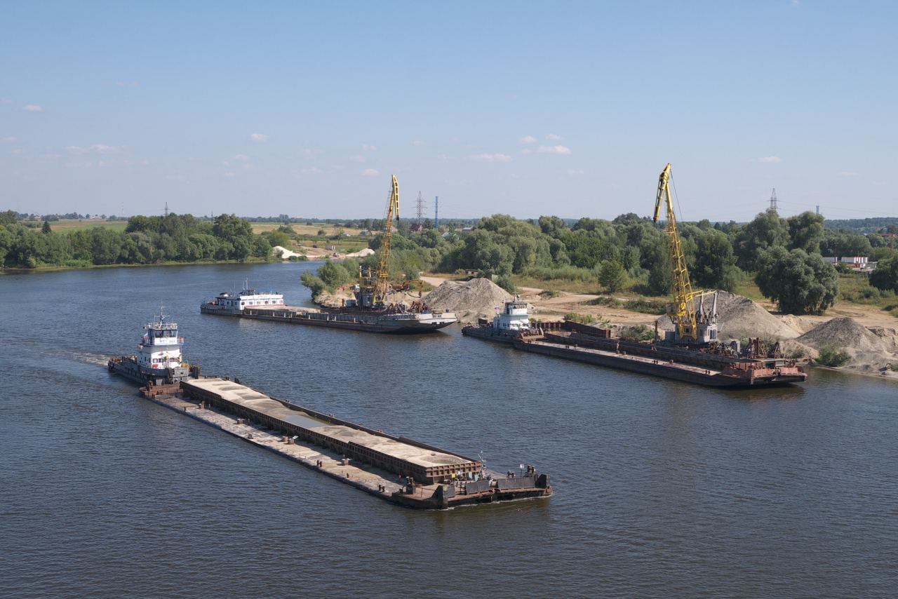 Dredge barge loaded with spoil alongside the bank