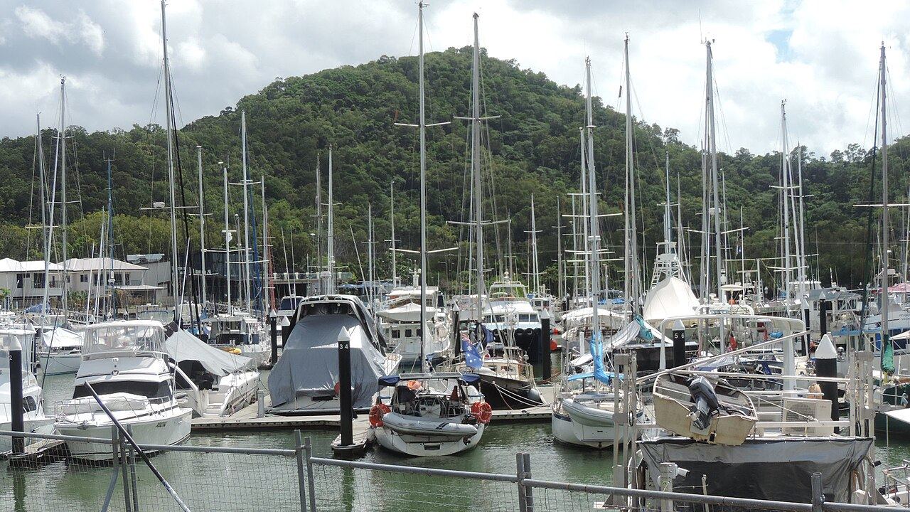 Yachts berthed along a marina arm