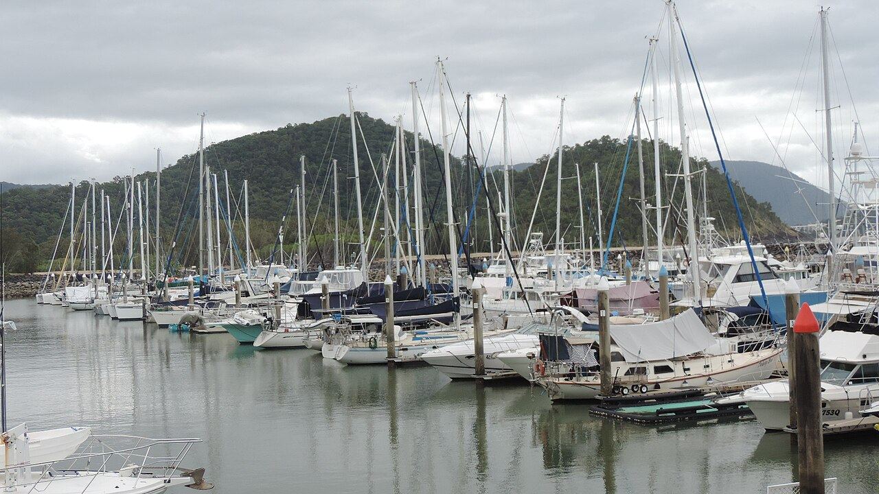 Marina basin with yachts and hills beyond