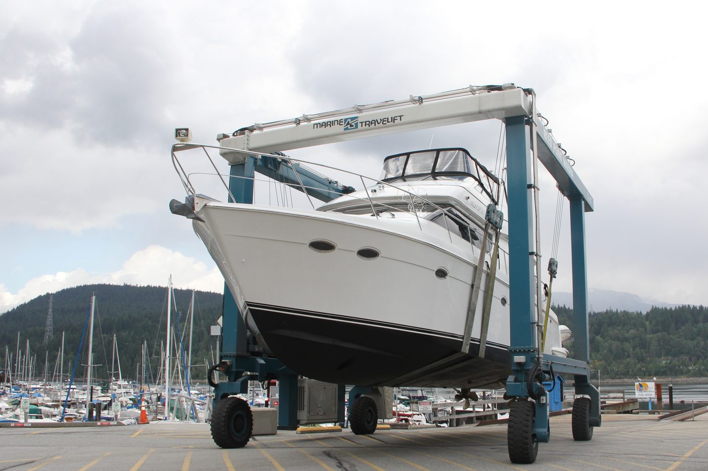 Travelift hauling a motor cruiser out of the water on a marina hardstand